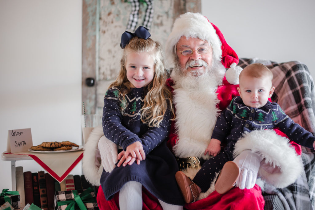 Santa Claus holding siblings during 2020 Santa Mini photo session