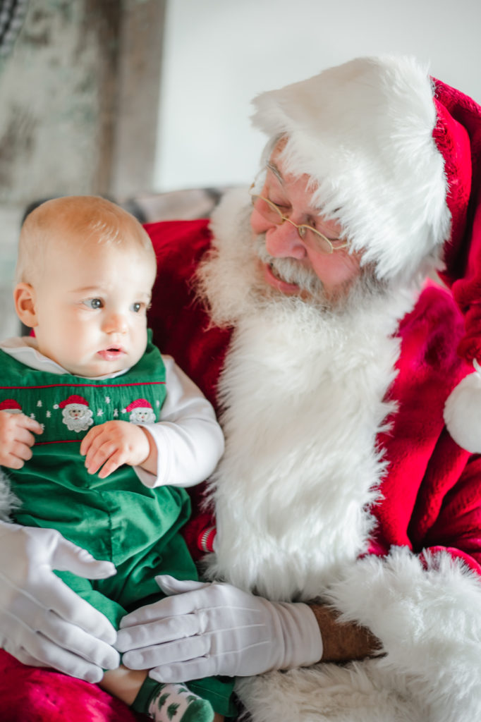 Santa Claus holding baby boy during 2020 Santa Mini photo session