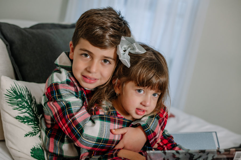 Siblings hugging during a family Christmas photo session in Chattanooga