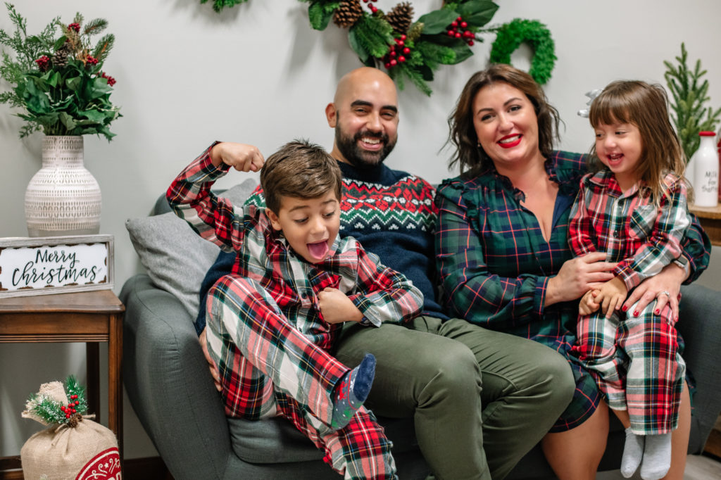 Diaz family sitting on couch during a family Christmas photo session in Chattanooga