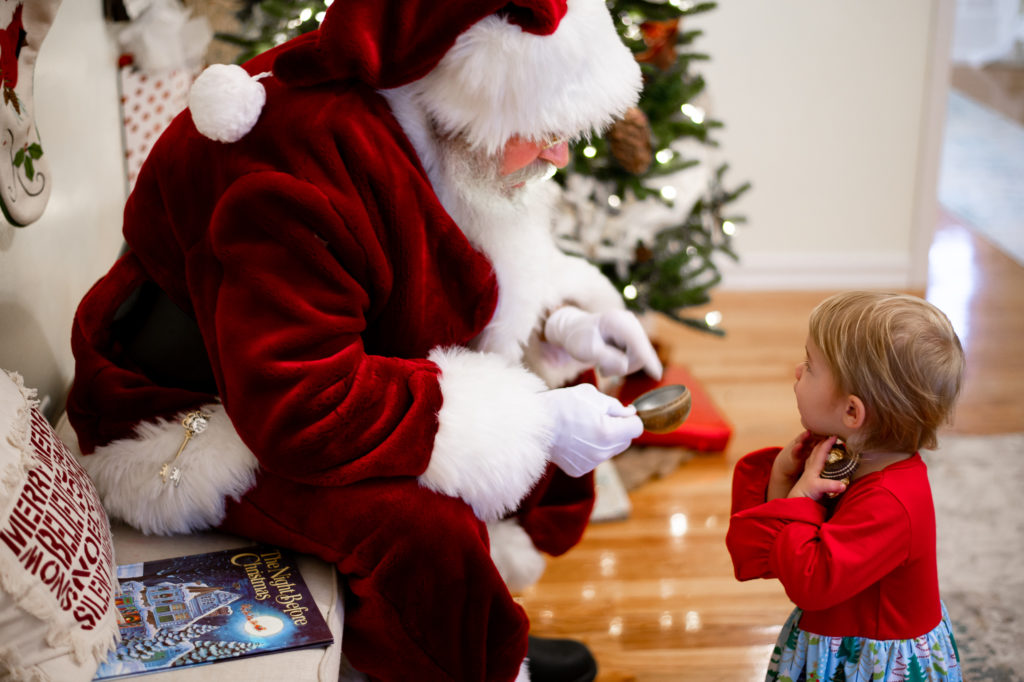 Santa and little girl interacting during 